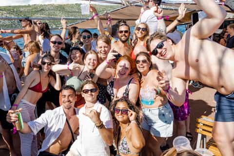 People on a boat party with drinks and dancing